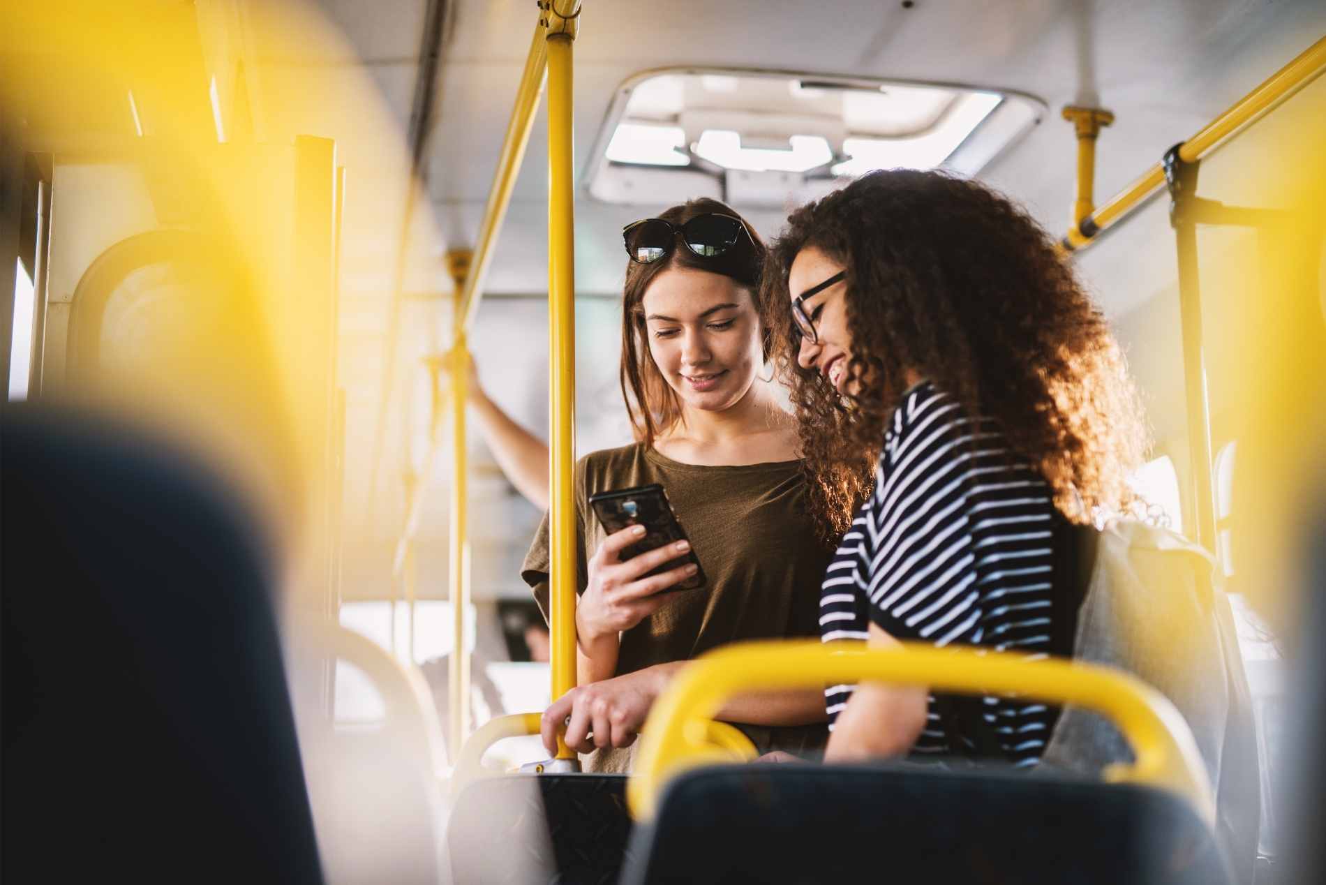 Smart Transportation - 2 females on phone on bus